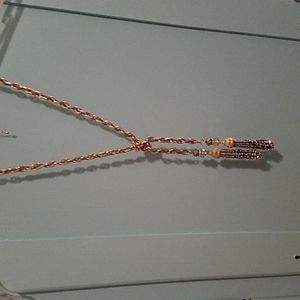 Necklace goldtone chain with silver tone tassels. Gray leather woven in